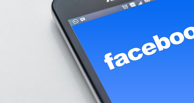 Facebook app on smartphone screen SociShare, Social Media Management