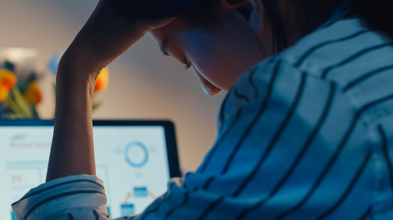 Person working at computer analyzing data, SociShare, Social Media Management