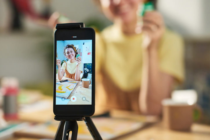 Person creating video content with smartphone, SociShare, Social Media Management
