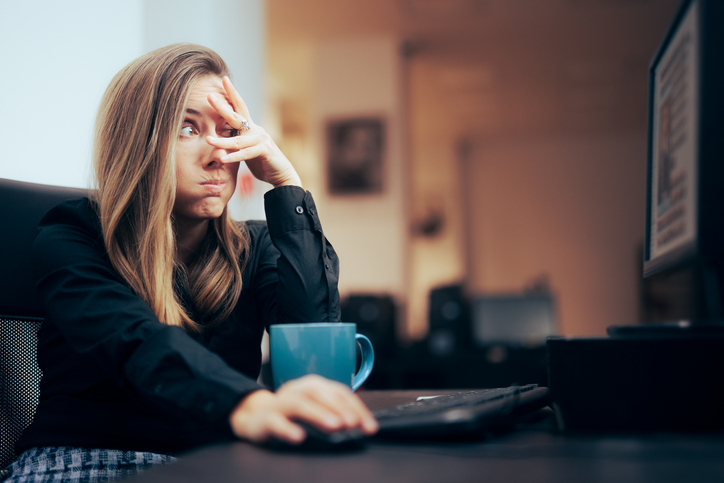 Woman looking stressed at computer screen, SociShare, Social Media Management