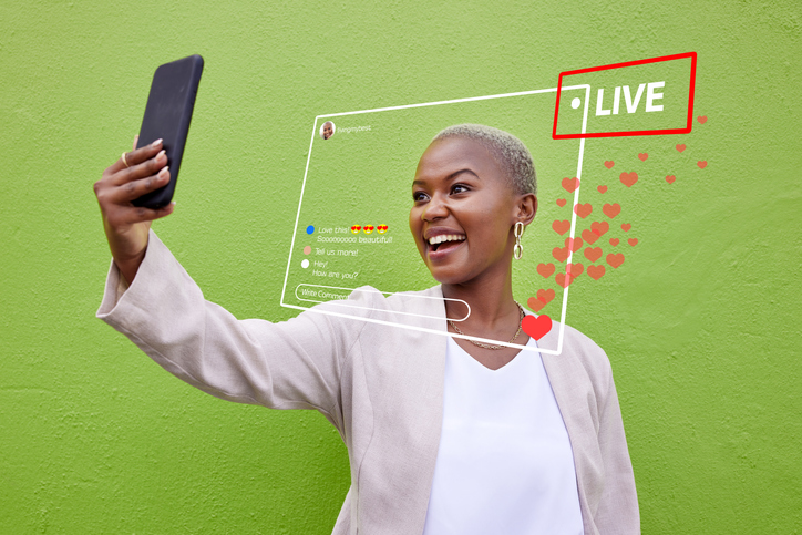 Person live streaming with smartphone outdoors, SociShare, Social Media Management