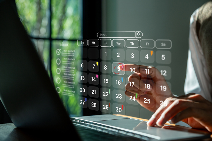 Person managing calendar on laptop screen, SociShare, Social Media Management