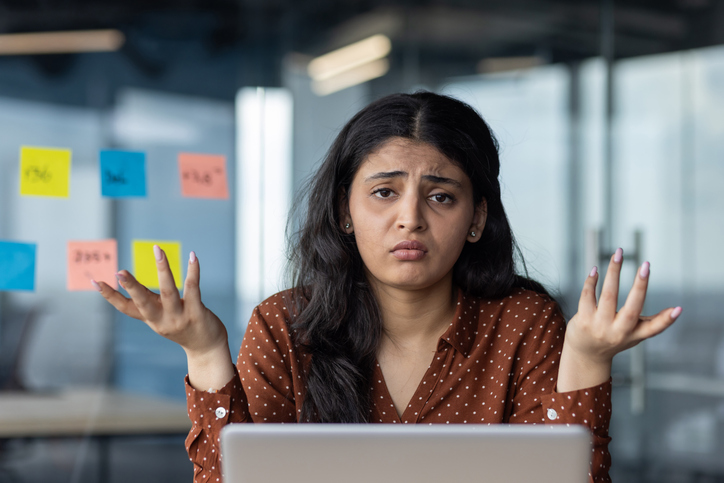 Confused woman looking at sticky notes, SociShare, Social Media Management