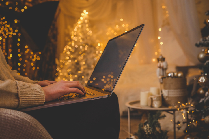 Cozy holiday atmosphere with person using laptop, SociShare, Social Media Management