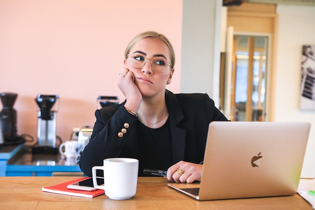 Person contemplating in front of laptop, SociShare, Social Media Management
